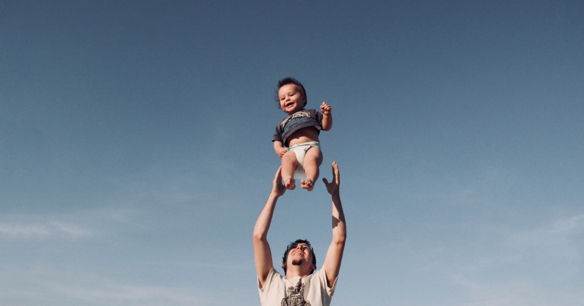 Dad throwing child in the air